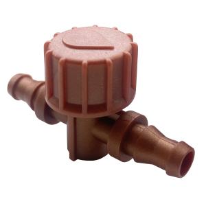 Close-up of a brown plastic toy hand gripping a ribbed cylindrical object with a round, cap-like top.